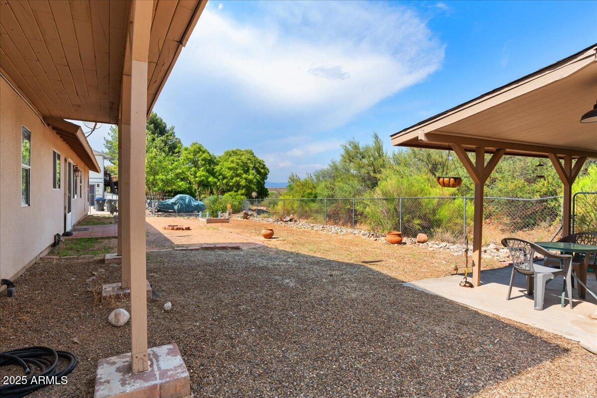 2527 Rio Verde Drive Cottonwood, AZ 86326 - Photo 31 of 43 a view of a patio with table and chairs under an umbrella