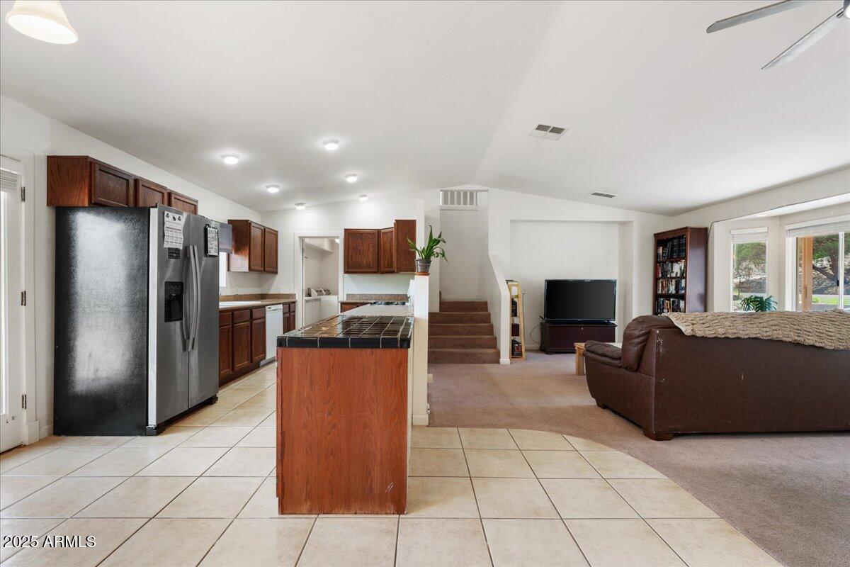 2527 Rio Verde Drive Cottonwood, AZ 86326 - Photo 8 of 43 a kitchen with stainless steel appliances kitchen island granite countertop a refrigerator and a sink