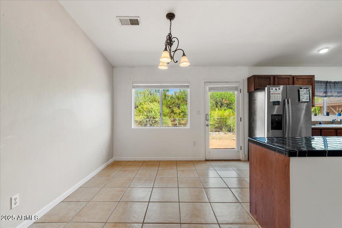 2527 Rio Verde Drive Cottonwood, AZ 86326 - Photo 9 of 43 a view of a room with a chandelier fan and windows