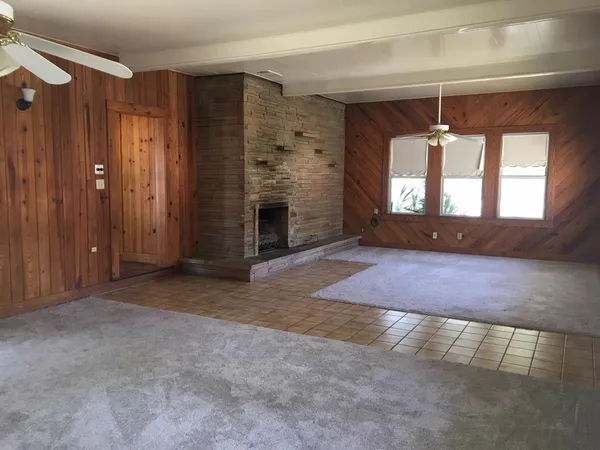 a view of empty room with a fireplace