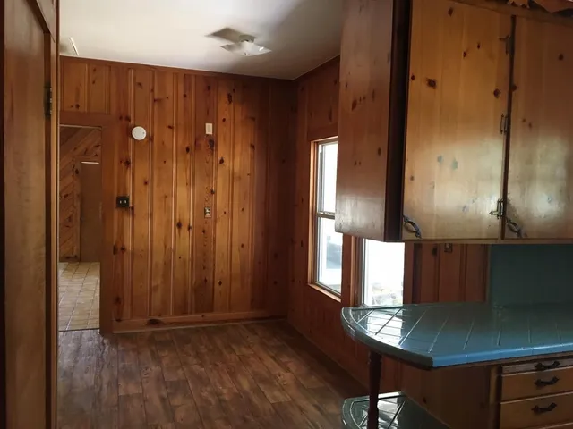 a room with wooden floor and a cabinet