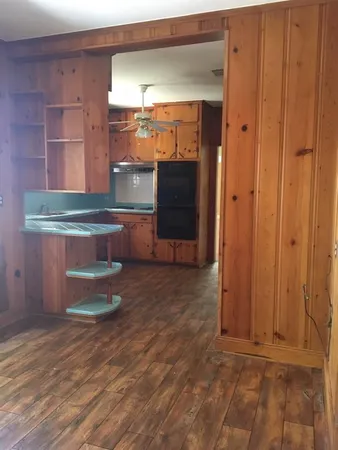 a room with wooden floors and a window