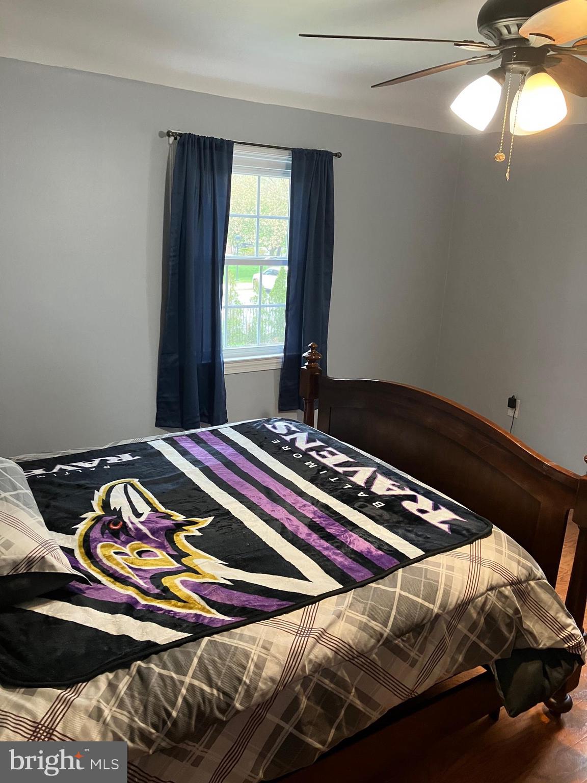 5111 Underwood Road Baltimore, MD 21212 - Photo 15 of 20 a bed sitting in a bedroom next to a window