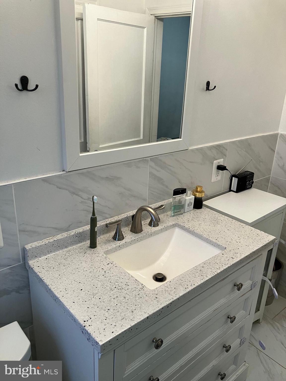 5111 Underwood Road Baltimore, MD 21212 - Photo 17 of 20 a bathroom with a sink and a mirror