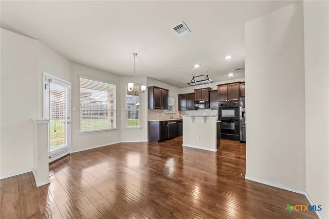 a view of a kitchen with a stove cabinets and wooden floor