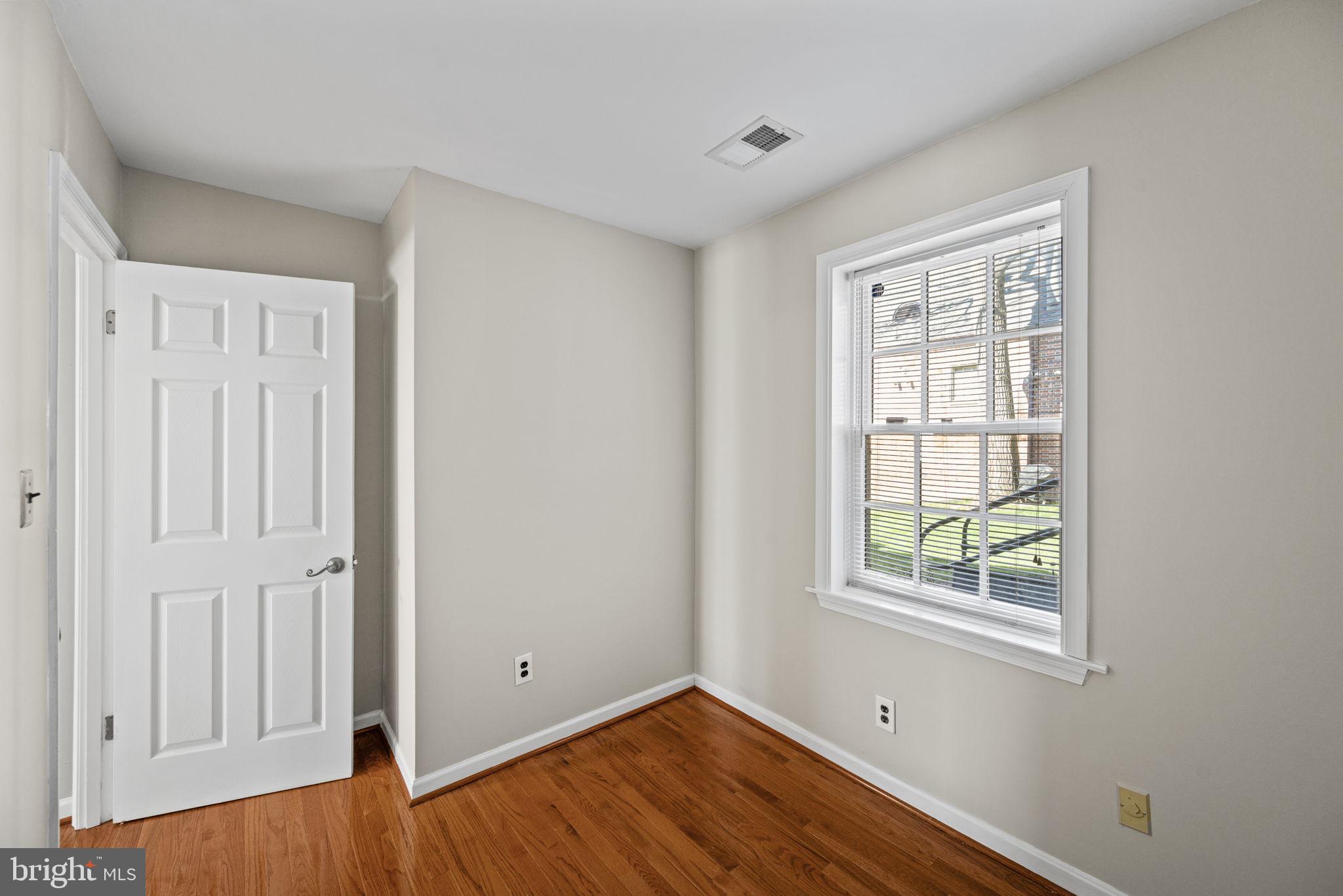 2001 Fort Davis Street Southeast, Unit 102 Washington, DC 20020 - Photo 12 of 30 an empty room with wooden floor and windows