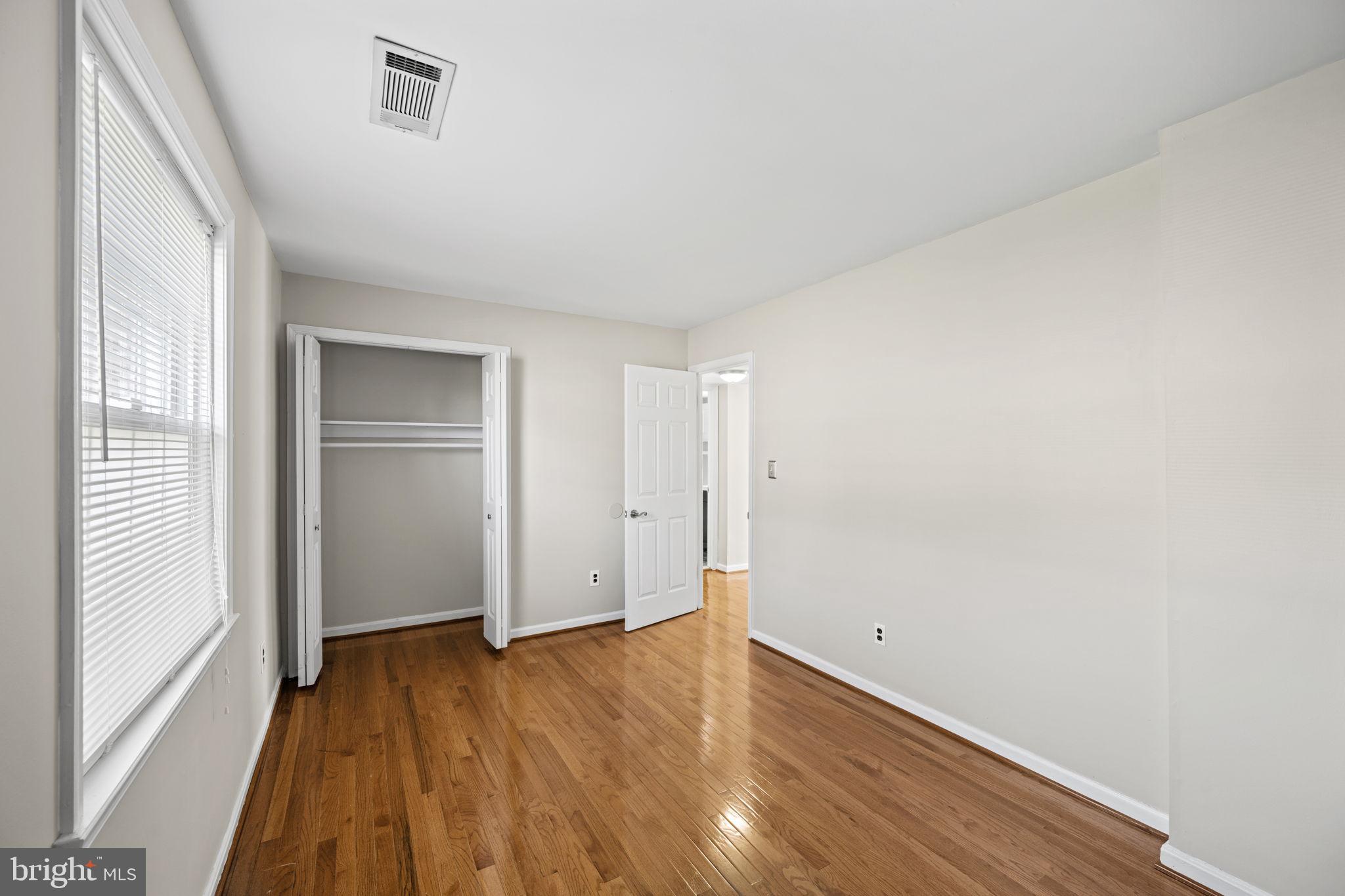 2001 Fort Davis Street Southeast, Unit 102 Washington, DC 20020 - Photo 15 of 30 a view of an empty room with wooden floor and a window