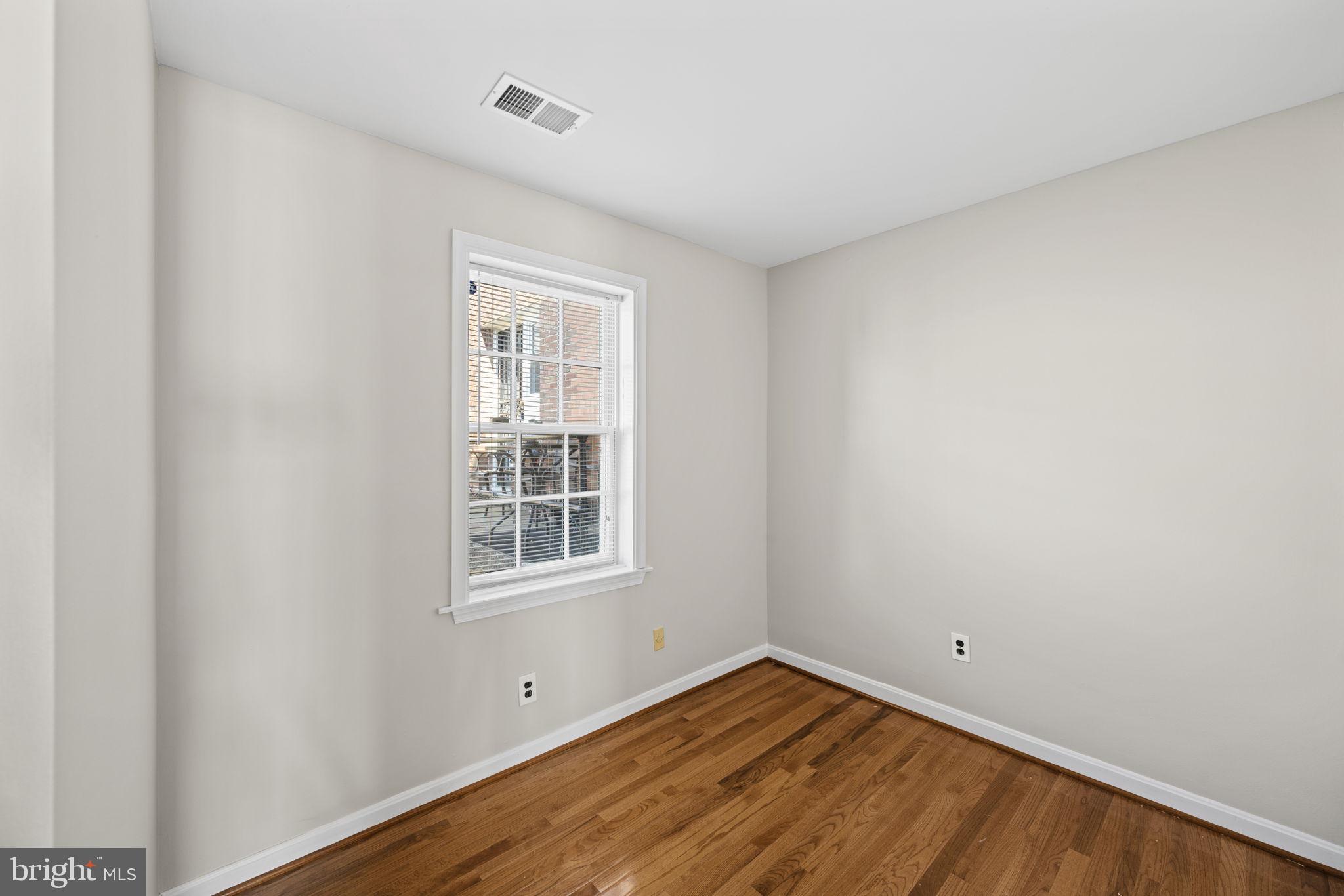 2001 Fort Davis Street Southeast, Unit 102 Washington, DC 20020 - Photo 16 of 30 a view of empty room with wooden floor and fan