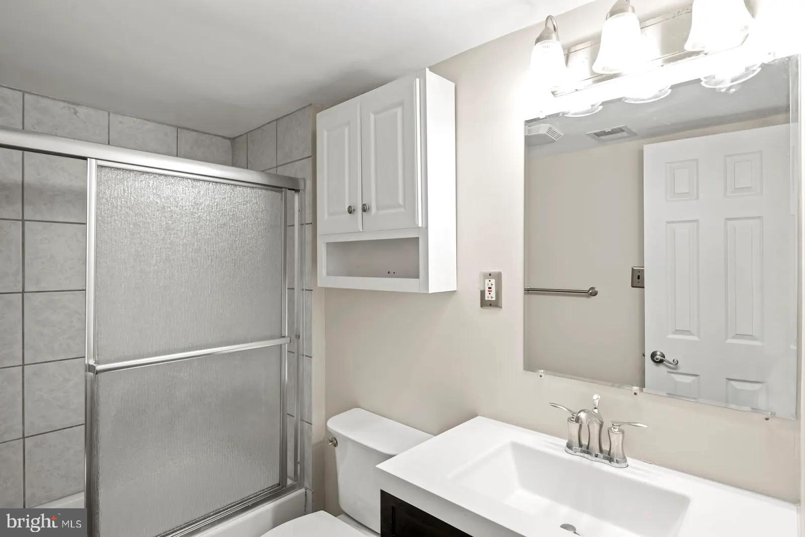 2001 Fort Davis Street Southeast, Unit 102 Washington, DC 20020 - Photo 19 of 30 a bathroom with a sink toilet and shower