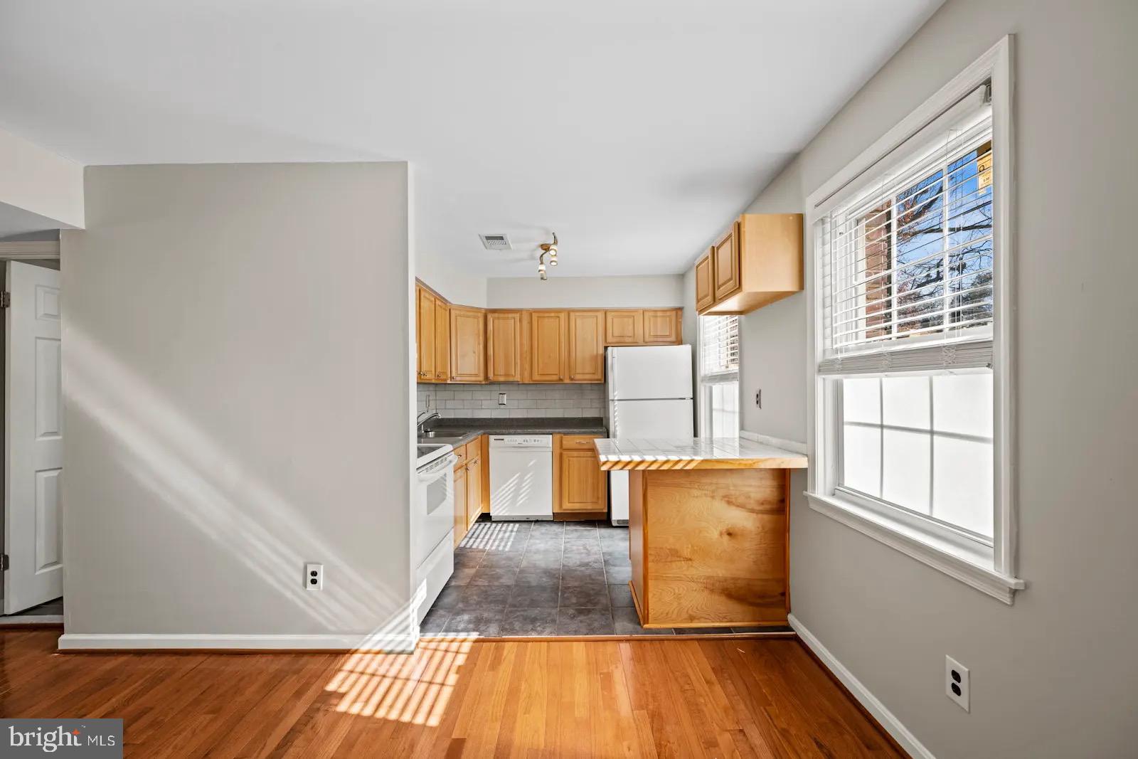2001 Fort Davis Street Southeast, Unit 102 Washington, DC 20020 - Photo 4 of 30 a view of kitchen with cabinets and wooden floor