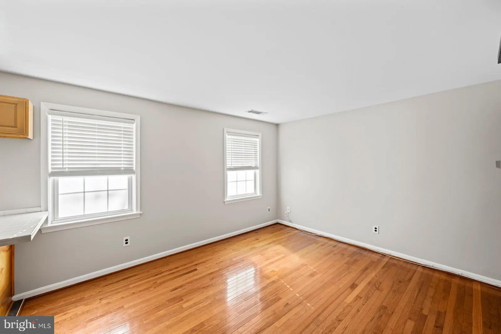 2001 Fort Davis Street Southeast, Unit 102 Washington, DC 20020 - Photo 8 of 30 an empty room with wooden floor and windows