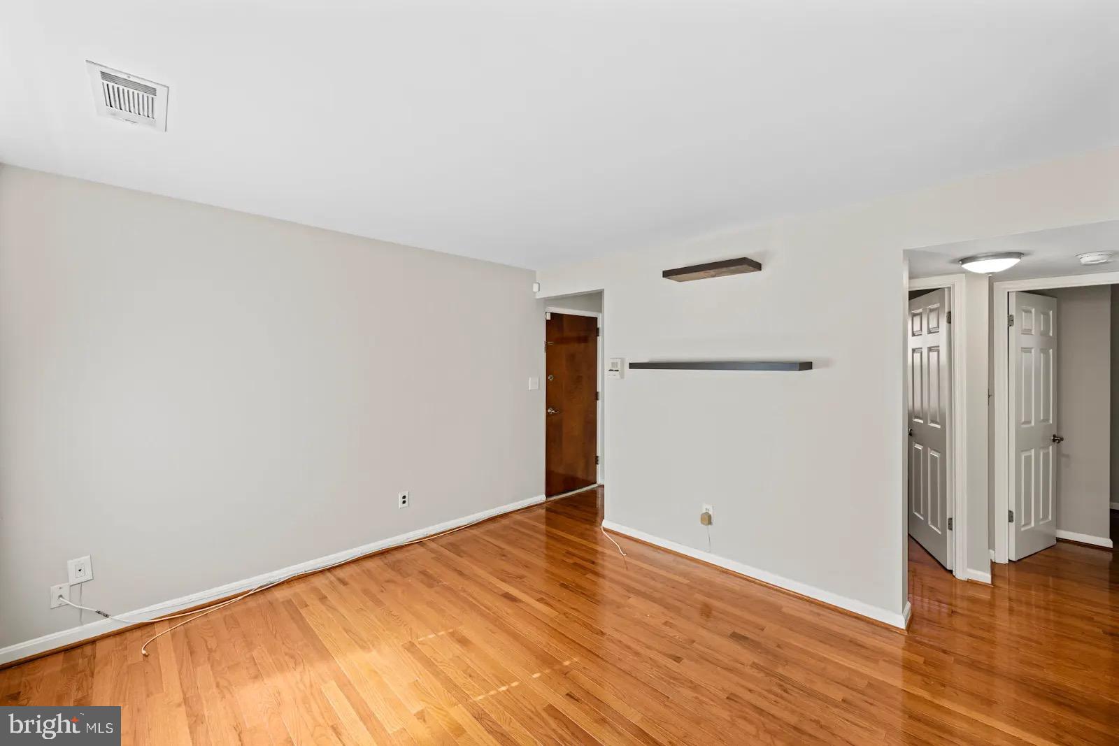 2001 Fort Davis Street Southeast, Unit 102 Washington, DC 20020 - Photo 9 of 30 wooden floor in an empty room
