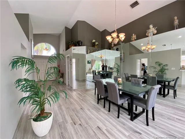 a view of a dining room with furniture and chandelier