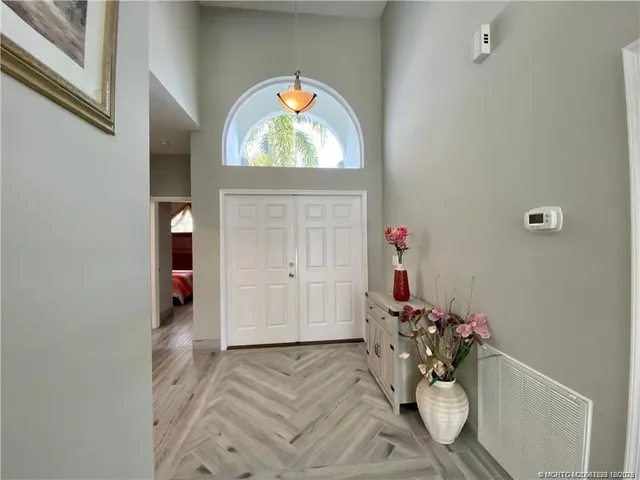 a view of a livingroom with wooden floor and a window