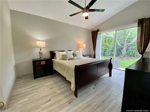 a bed room with a bed and a large window