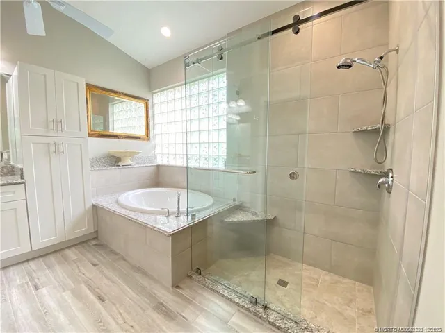 a bathroom with a tub shower and sink