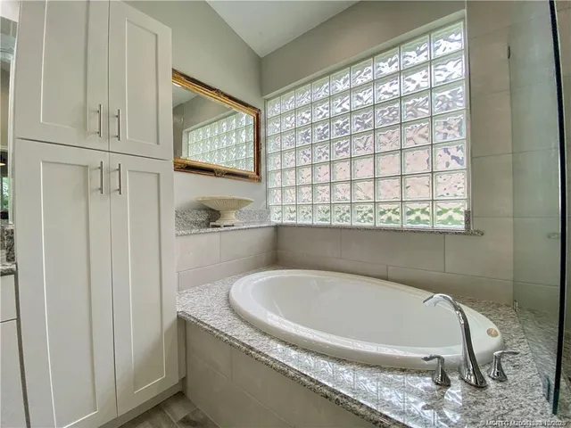 a white bath tub sitting next to a window