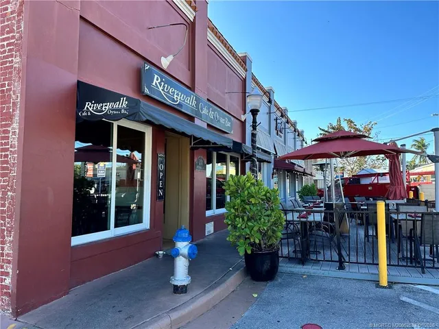 a front view of a building with sitting area
