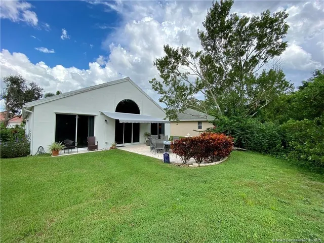 a front view of a house with a garden and plants