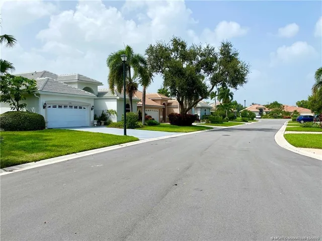 a view of a fountain with a big yard and palm trees