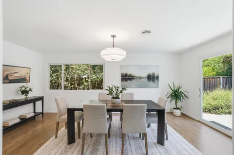 a view of a dining room with furniture window and outside view