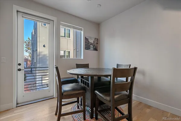 a kitchen with a table chairs refrigerator and microwave