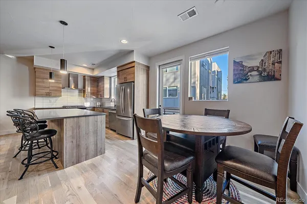 a kitchen with stainless steel appliances granite countertop a sink a stove and a refrigerator