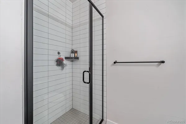 a bathroom with a toilet a sink a tub and mirror