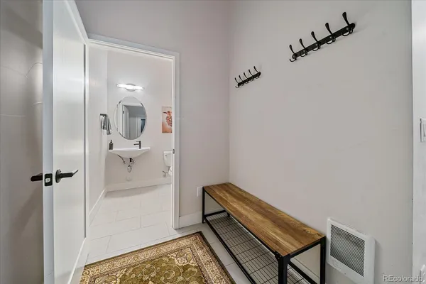 a living room with a couch and a refrigerator