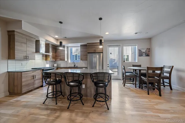 a view of a dining room with furniture and wooden floor