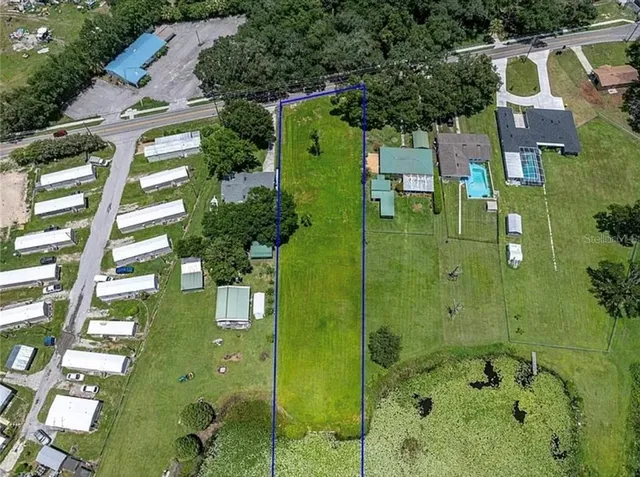 aerial view of a residential apartment building with a yard