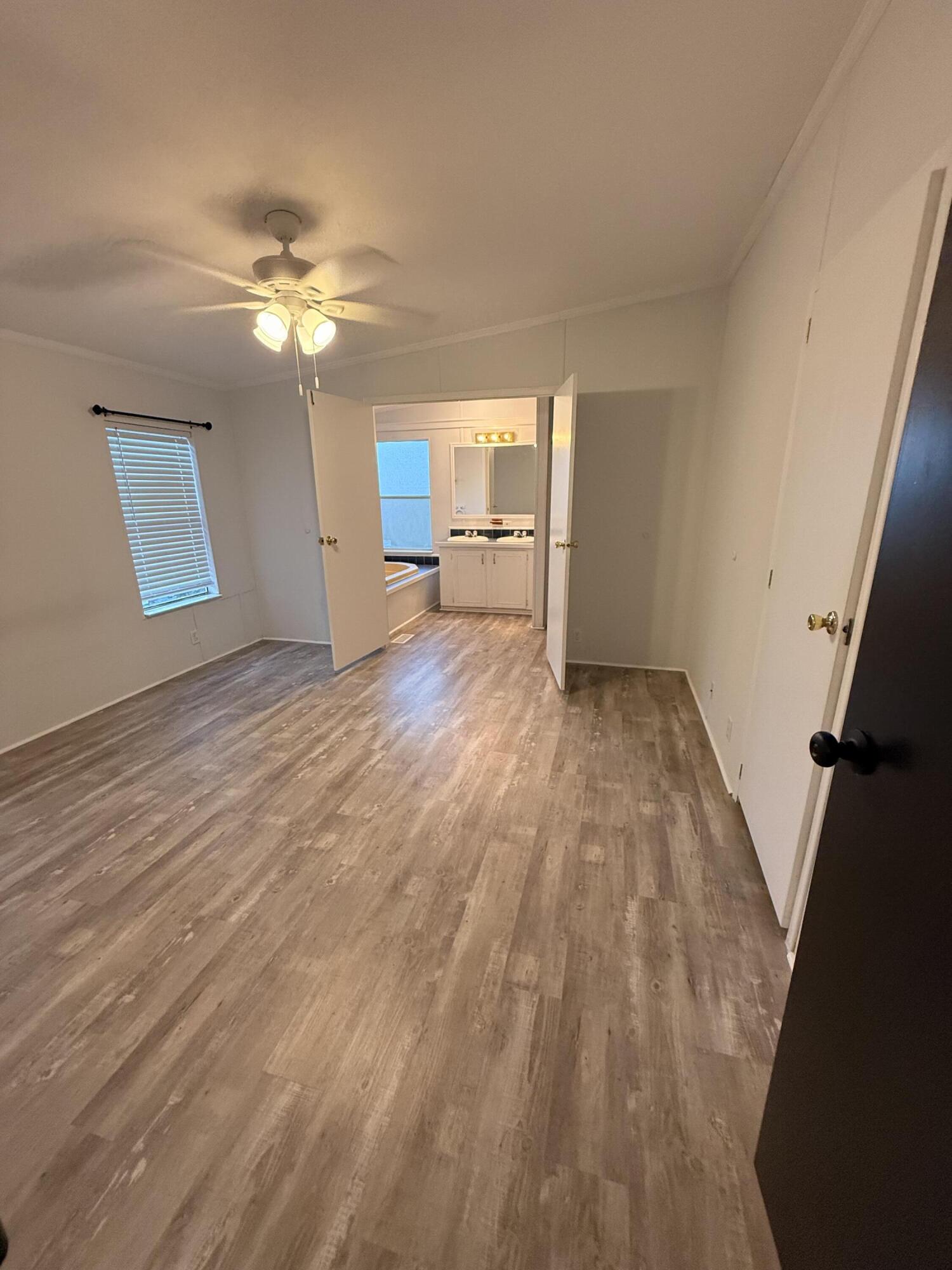 300 Ridgewood Avenue Mary Esther, FL 32569 - Photo 14 of 15 a view of a room with wooden floor and a ceiling fan