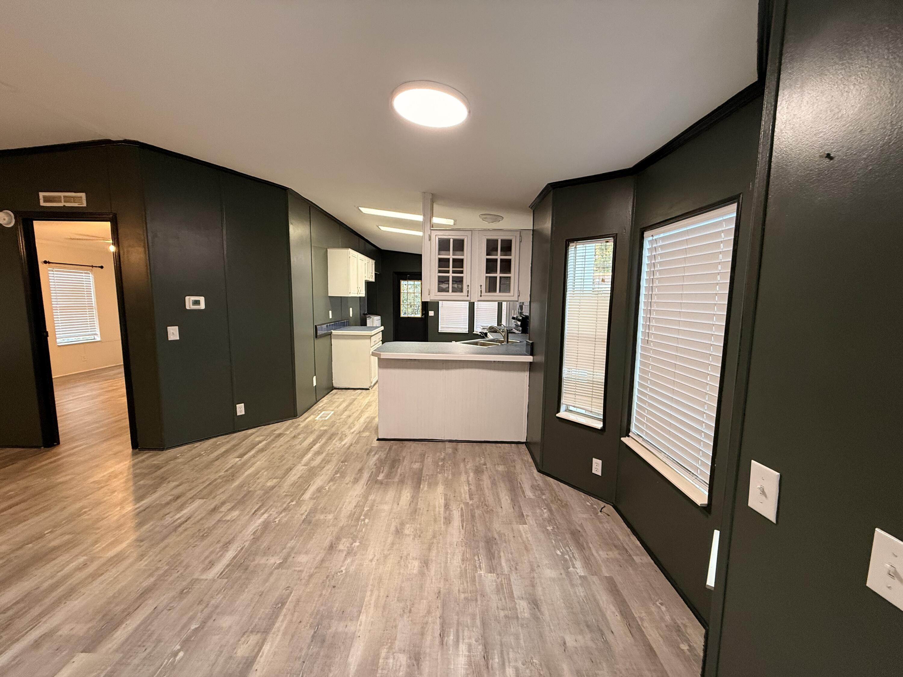 300 Ridgewood Avenue Mary Esther, FL 32569 - Photo 8 of 15 a view of a kitchen with refrigerator and wooden floor