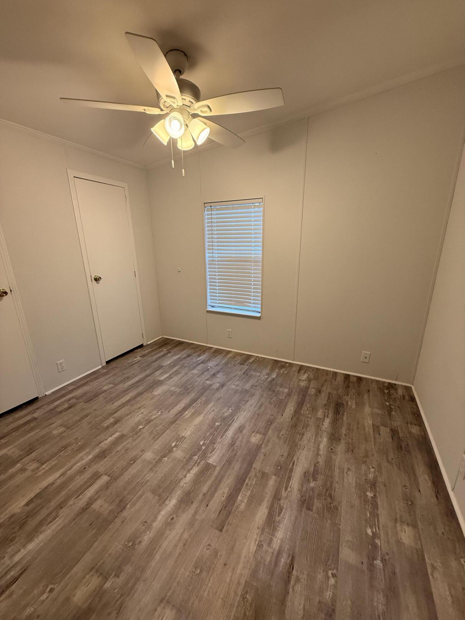 300 Ridgewood Avenue Mary Esther, FL 32569 - Photo 9 of 15 wooden floor in an empty room with a window