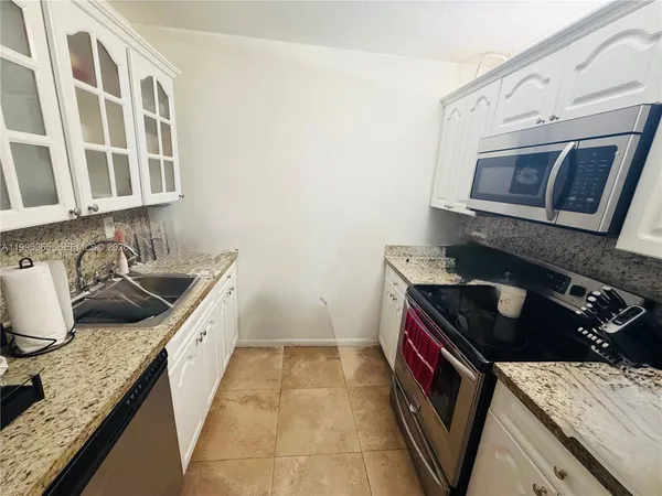 a kitchen that has a sink and a stove