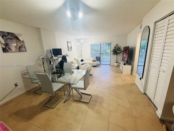 a view of a livingroom with furniture and a flat screen tv