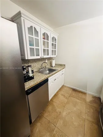 a kitchen with stainless steel appliances a refrigerator and cabinets