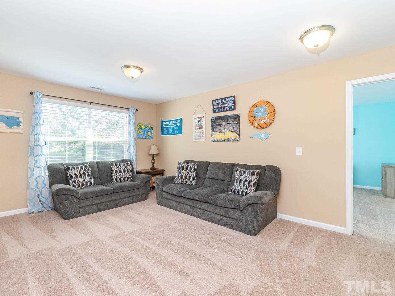 204 Hope Valley Road Knightdale, NC 27545 - Photo 15 of 30 a living room with couches and a large window with garden view