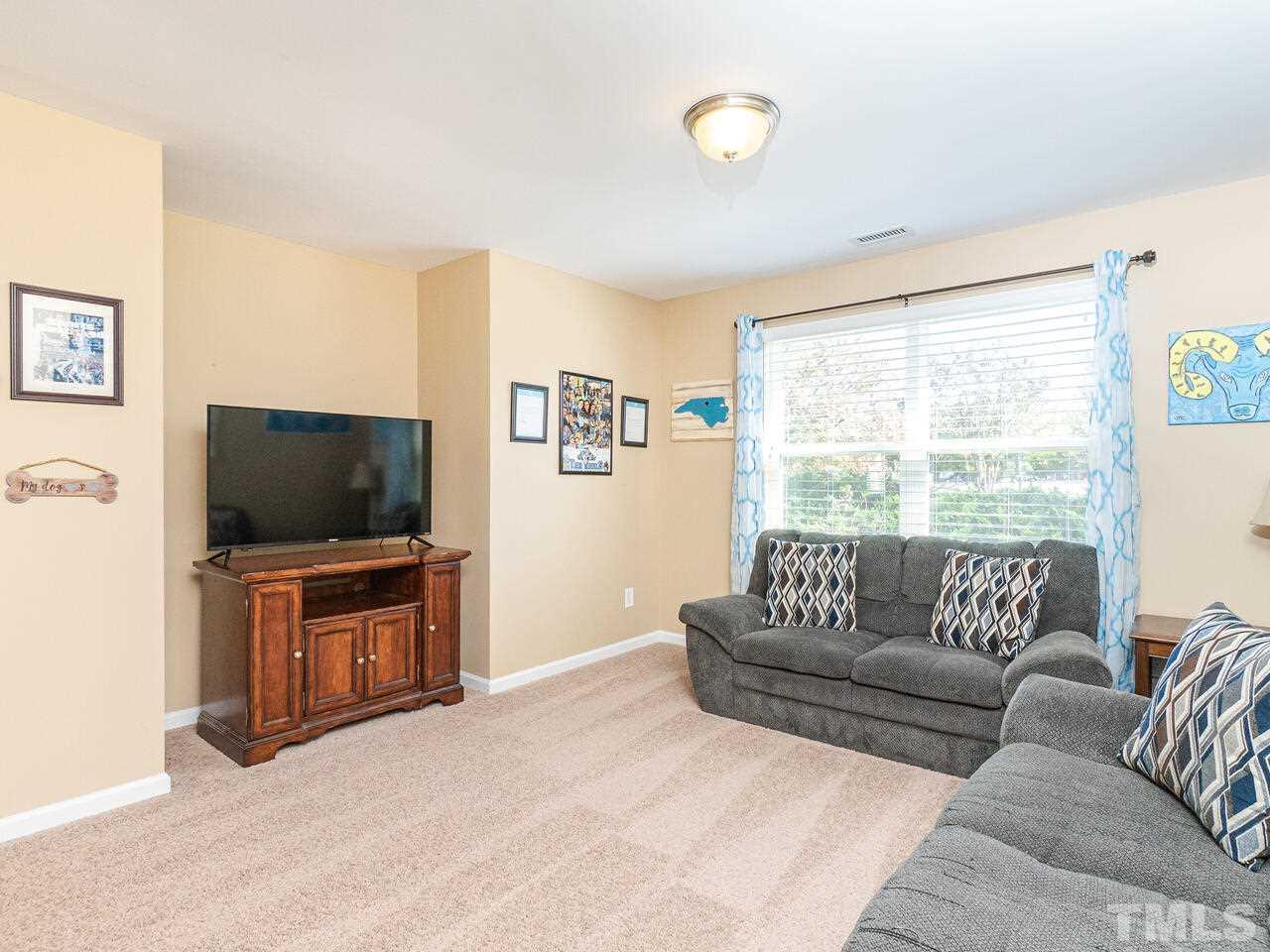 204 Hope Valley Road Knightdale, NC 27545 - Photo 16 of 30 a living room with furniture and a flat screen tv
