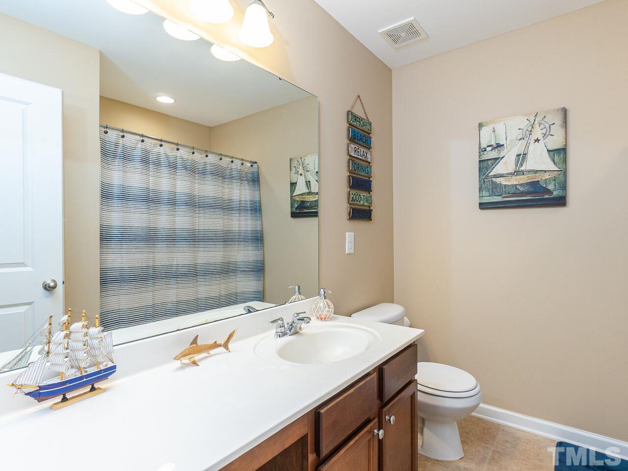 204 Hope Valley Road Knightdale, NC 27545 - Photo 17 of 30 a bathroom with a sink a toilet and shower