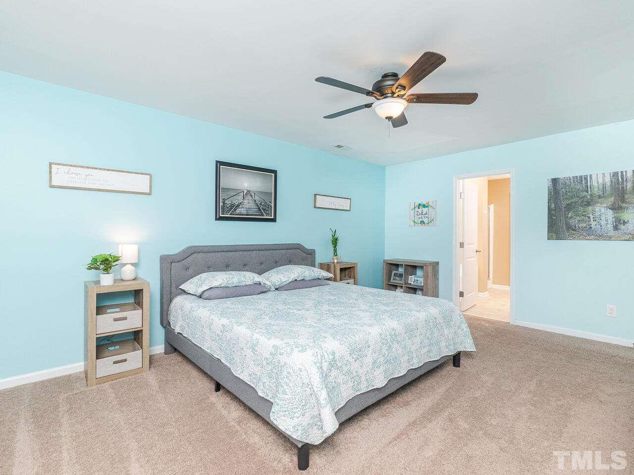 204 Hope Valley Road Knightdale, NC 27545 - Photo 21 of 30 a bedroom with a large bed and a ceiling fan