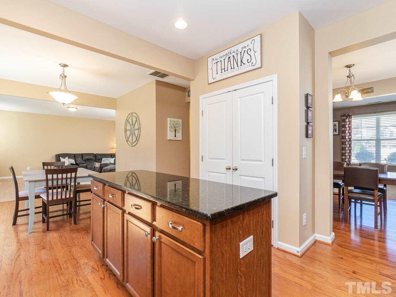204 Hope Valley Road Knightdale, NC 27545 - Photo 9 of 30 a kitchen with stainless steel appliances granite countertop a refrigerator a stove and a sink with granite countertops