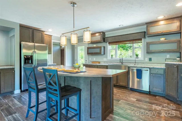 a kitchen with a sink a counter and chairs