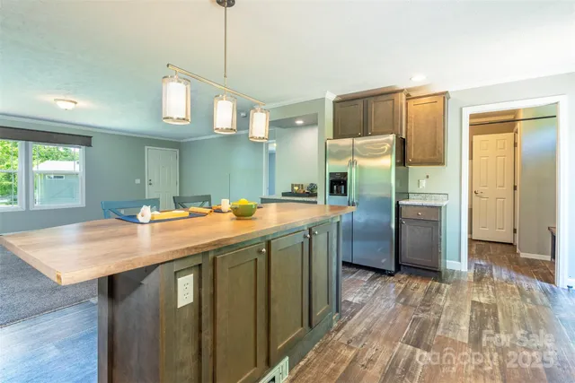 a kitchen with stainless steel appliances granite countertop a sink a refrigerator and a stove