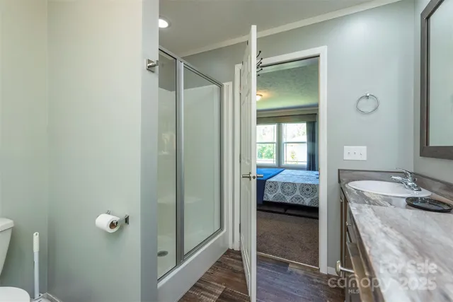 a bedroom with a bed and wooden floor