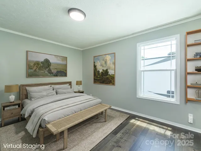 a bedroom with a bed and a painting on the wall