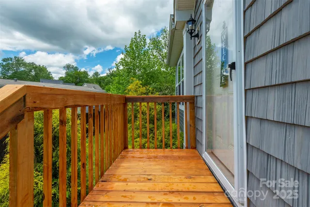 a view of a wooden deck front of house