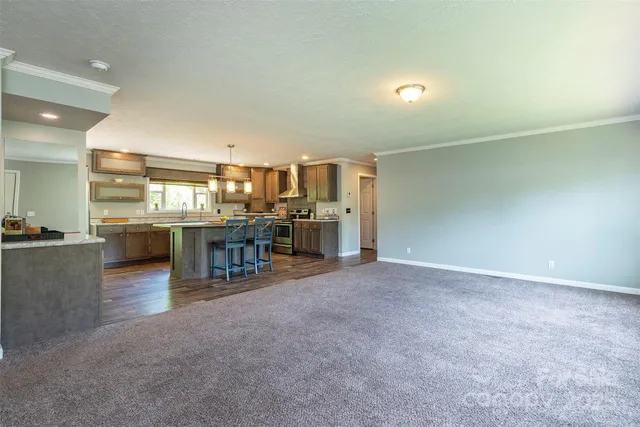 a view of a livingroom with furniture and a kitchen