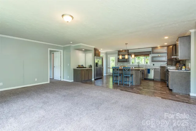 a view of a kitchen with refrigerator and a sink