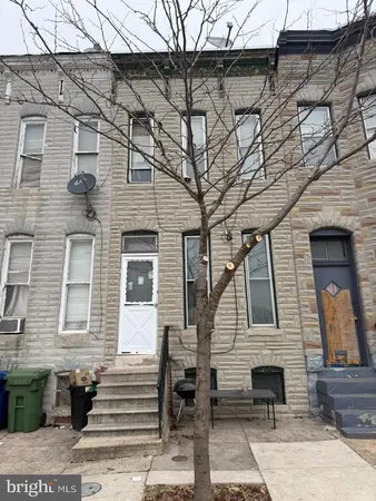 a front view of a house with a bench